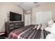 Bedroom with a king-size bed and large TV at 27227 N 171St Dr, Surprise, AZ 85387