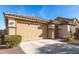 Tan house with two-car garage and desert landscaping at 27227 N 171St Dr, Surprise, AZ 85387