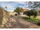 Backyard with desert landscaping, mature citrus trees and block wall at 4709 W Westcott Dr, Glendale, AZ 85308