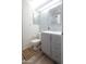 Updated bathroom with a gray vanity, patterned tile backsplash, and wood look flooring at 4709 W Westcott Dr, Glendale, AZ 85308