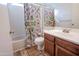 Bathroom with colorful shower curtain, tub-shower, and vanity at 4709 W Westcott Dr, Glendale, AZ 85308