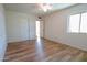 Bright bedroom features wood-look laminate flooring, a ceiling fan, and large window at 4709 W Westcott Dr, Glendale, AZ 85308