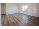 Cozy bedroom featuring new floors, a large window and a neutral color palette at 4709 W Westcott Dr, Glendale, AZ 85308