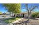 House with a large front yard, basketball hoop, and mature trees at 5625 N 67Th Dr, Glendale, AZ 85303