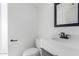 Bathroom boasts a white vanity, black matte fixtures, and a toilet at 609 W Grandview Rd, Phoenix, AZ 85023