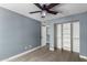 Bedroom with gray walls, ceiling fan, and walk-in closet at 609 W Grandview Rd, Phoenix, AZ 85023