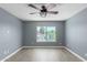 Bright bedroom with ceiling fan and large window offering natural light at 609 W Grandview Rd, Phoenix, AZ 85023