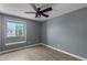 Bright bedroom with wood-look floors, ceiling fan, and window seat at 609 W Grandview Rd, Phoenix, AZ 85023