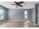 Bedroom with gray walls, wood floors, and multiple windows at 609 W Grandview Rd, Phoenix, AZ 85023