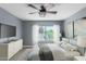 Spacious bedroom with a ceiling fan, large window, and gray walls at 609 W Grandview Rd, Phoenix, AZ 85023