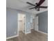 Bedroom with gray walls, ceiling fan, and access to closets at 609 W Grandview Rd, Phoenix, AZ 85023