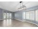 Dining room with gray walls, wood floors, and a view to the front door and windows at 609 W Grandview Rd, Phoenix, AZ 85023