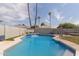 Relaxing kidney-shaped pool with waterfall and safety fence at 609 W Grandview Rd, Phoenix, AZ 85023