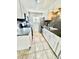 Well-lit kitchen featuring stainless steel appliances and white cabinets at 6125 E Indian School Rd # 167, Scottsdale, AZ 85251