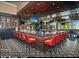 Modern bar with red barstools and a large TV at 9542 E Sunridge Dr, Sun Lakes, AZ 85248