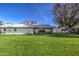 Backyard view showing patio and grassy lawn at 10113 W Kingswood Cir, Sun City, AZ 85351