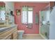 Clean bathroom featuring a shower and updated vanity at 10113 W Kingswood Cir, Sun City, AZ 85351