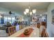 Open concept dining room with kitchen views and seating for six at 10113 W Kingswood Cir, Sun City, AZ 85351