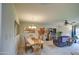 Bright dining room with seating for six and adjacent living area at 10113 W Kingswood Cir, Sun City, AZ 85351