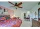 Main bedroom with a king-size bed and ceiling fan at 10113 W Kingswood Cir, Sun City, AZ 85351