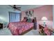 Main bedroom featuring a king-size bed and ceiling fan at 10113 W Kingswood Cir, Sun City, AZ 85351