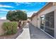 Landscaped backyard pathway leading to patio and other features at 10442 E Flintlock Dr, Sun Lakes, AZ 85248