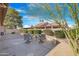 Charming backyard patio with seating area and desert landscaping at 10442 E Flintlock Dr, Sun Lakes, AZ 85248