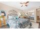 Well-lit bedroom with mirrored closet doors and ceiling fan at 10442 E Flintlock Dr, Sun Lakes, AZ 85248