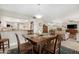 Open concept dining area with table and chairs, kitchen and living room visible at 10442 E Flintlock Dr, Sun Lakes, AZ 85248