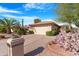 Single-story home with desert landscaping and a two-car garage at 10442 E Flintlock Dr, Sun Lakes, AZ 85248