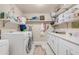 Spacious laundry room with ample shelving and storage at 10442 E Flintlock Dr, Sun Lakes, AZ 85248