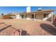 Spacious backyard with covered patio and gravel landscaping at 10831 W Laurie Ln, Peoria, AZ 85345