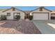 White single story home with two-car garage and landscaped front yard at 10831 W Laurie Ln, Peoria, AZ 85345