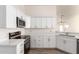 Modern kitchen with white cabinets, stainless steel appliances, and quartz countertops at 10831 W Laurie Ln, Peoria, AZ 85345