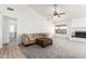 Bright living room features a fireplace and sliding glass door leading to the backyard at 10831 W Laurie Ln, Peoria, AZ 85345