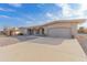 Front view of a tan, single-story house with a two-car garage at 10845 W Kaibab Dr, Sun City, AZ 85373