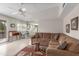 L-shaped sectional couch, tile floor, and view into the kitchen area at 10845 W Kaibab Dr, Sun City, AZ 85373