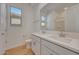 Well-lit bathroom with double sinks, modern fixtures, and wood-look tile flooring for a clean aesthetic at 14778 W Tether Trl, Surprise, AZ 85387