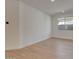 Minimalist bedroom with wood-look tile flooring, a window, and neutral paint at 14778 W Tether Trl, Surprise, AZ 85387