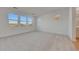 Bright bonus room with carpet flooring, multiple windows, and ample natural light providing versatility at 14778 W Tether Trl, Surprise, AZ 85387