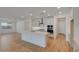 Bright kitchen with a central island, white cabinets, and stainless steel appliances at 14778 W Tether Trl, Surprise, AZ 85387