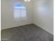 Bright bedroom with carpeted floors and an arched window at 16621 S 44Th Pl, Phoenix, AZ 85048