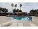 Community pool with lounge chairs and a covered area at 16621 S 44Th Pl, Phoenix, AZ 85048