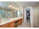 Double vanity bathroom with walk-in closet access at 17409 N Horseshoe Dr, Surprise, AZ 85374