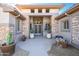 Inviting entryway with stone accents and mature plants at 17409 N Horseshoe Dr, Surprise, AZ 85374