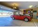 Garage with overhead storage and a car at 17409 N Horseshoe Dr, Surprise, AZ 85374