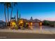 Attractive single-story home with desert landscaping at dusk at 17409 N Horseshoe Dr, Surprise, AZ 85374