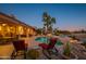 Evening view of the pool and patio area with lounge chairs at 17409 N Horseshoe Dr, Surprise, AZ 85374