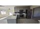 Modern kitchen with gray cabinets, quartz countertops, and stainless steel appliances at 17830 N 30Th St, Phoenix, AZ 85032