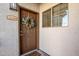 Condo entrance with brown door, wreath, and security system at 1941 S Pierpont Dr # 2098, Mesa, AZ 85206